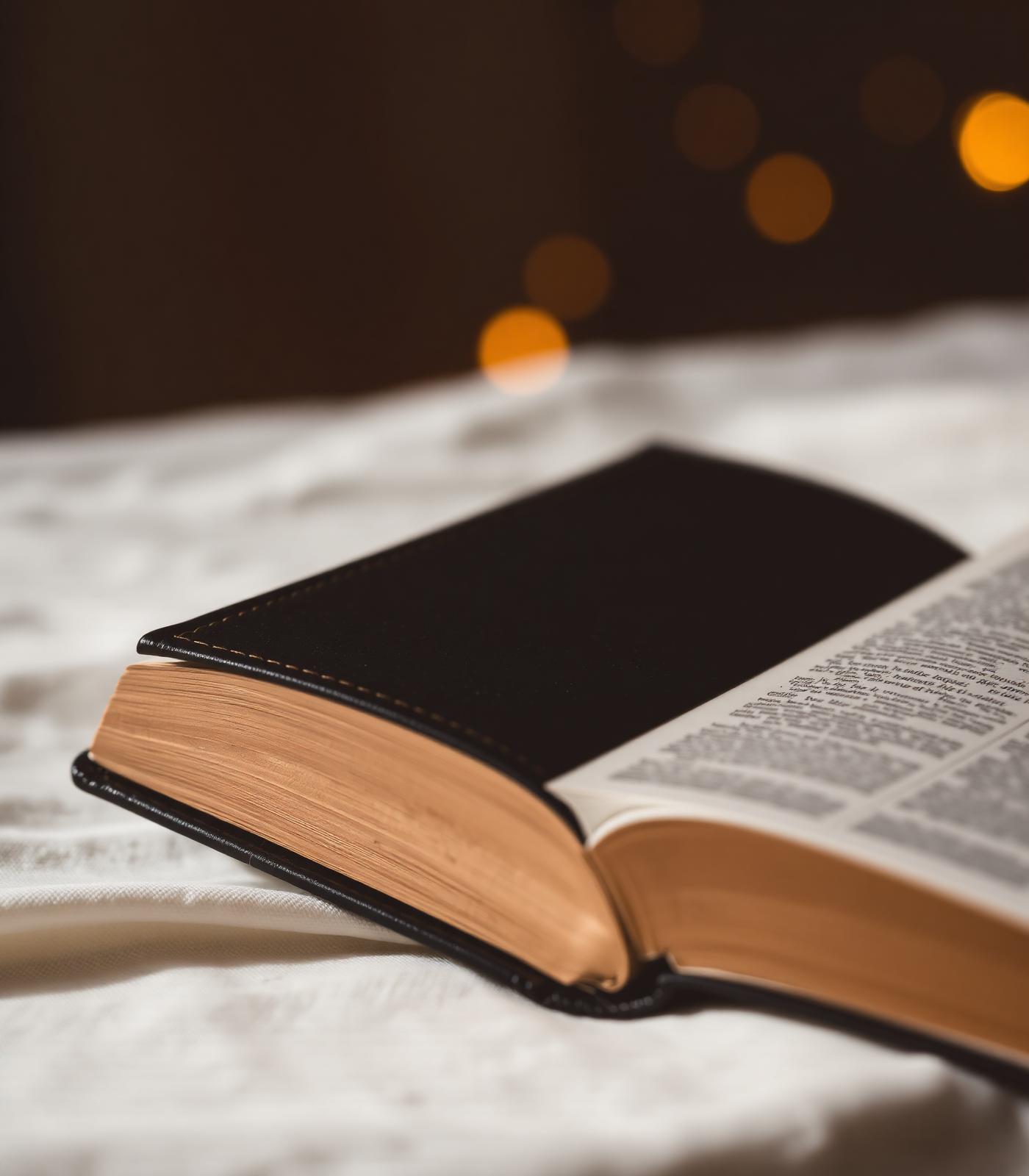 Open Bible with warm candle glow